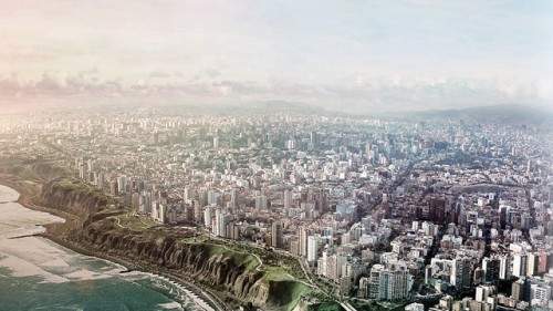 An aerial view of a densely populated city perched on the edge of an eroding landscape