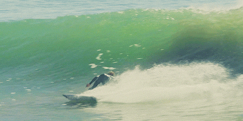 A gif of a surfer cutting back on top of a wave