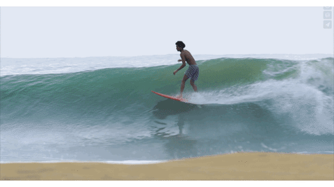 Surfer Mikey February flowing down the line on a wave
